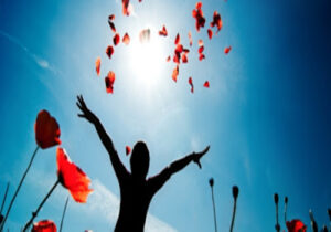 Girl stands in poppy field